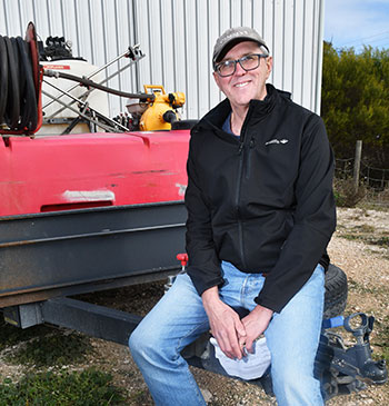 Dr Greg Rebetzke sitting on a trailor