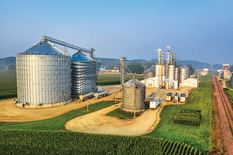 a series of silos in the landscape with blue sky