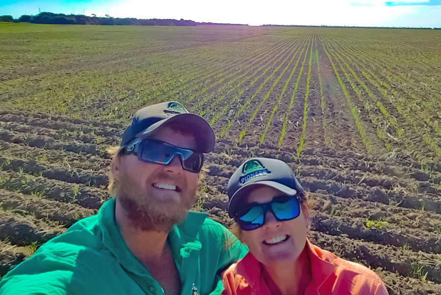 Jake and Felicity Hamilton picture in a growing crop. Both are smiling at the camera 