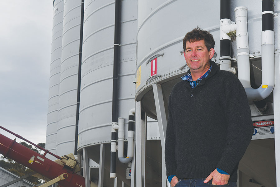 Andy Tucker standing in front of silos