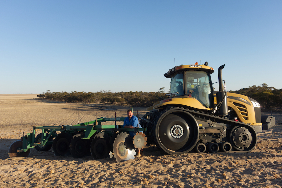 Rob with the tractor-towed plough and sow machine.