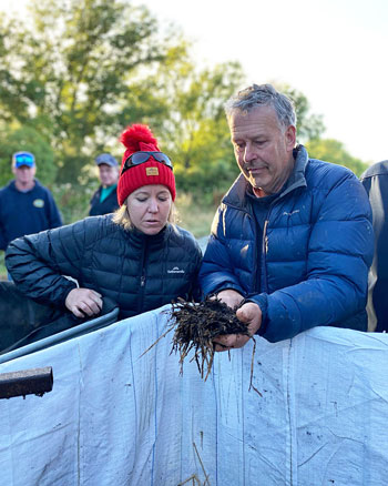 Mallee grower Carol Fitzpatrick and New Zealand grower James Halford look at compost he is making on his farm.