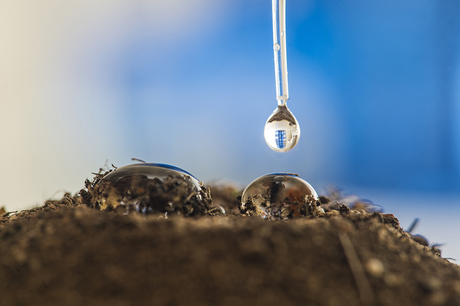 water beading on the surface of non-wetting sand.