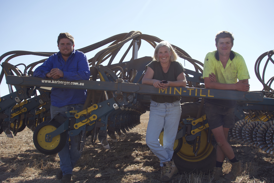 Alex Boehm (left), Lou Flohr and Damon Perks with seeding machine in paddock 