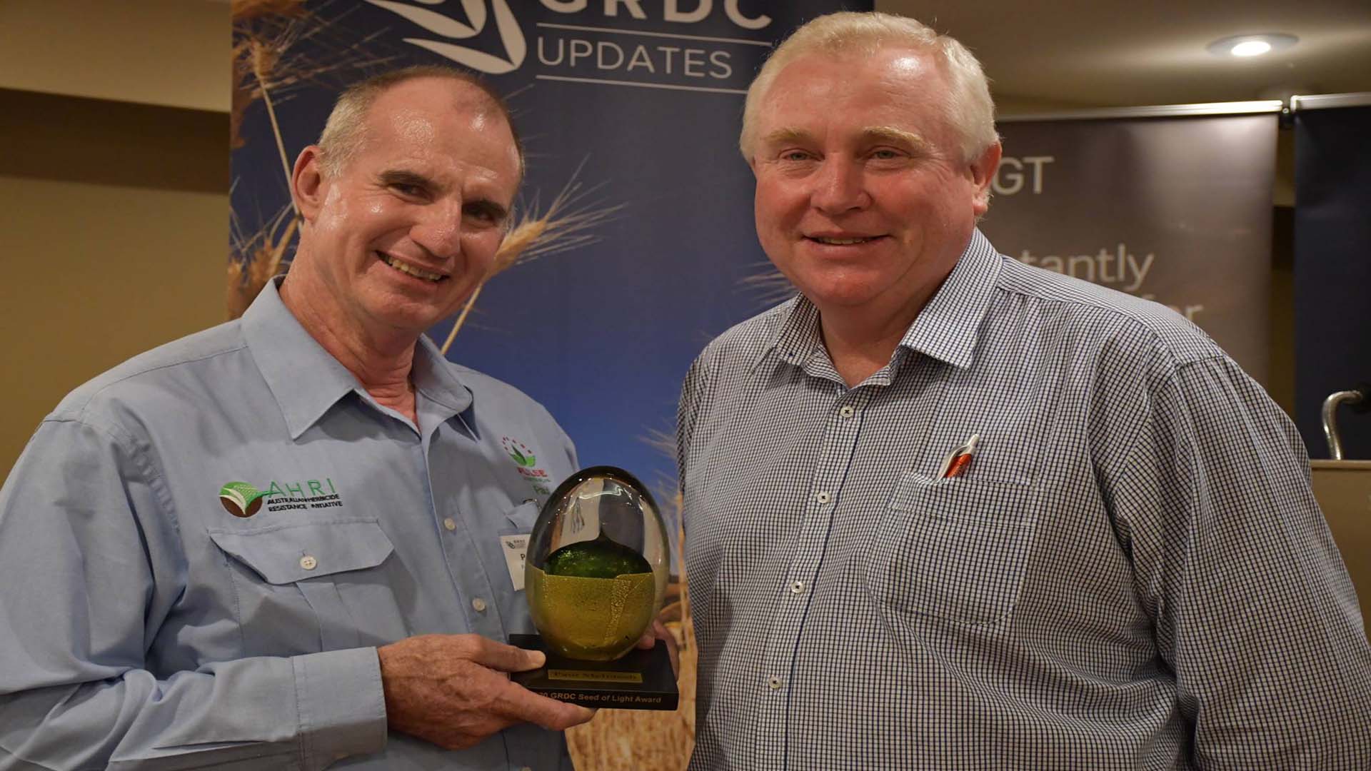 Well-known agronomist Paul McIntosh, left, was acknowledged for his tireless dedication to the grains industry with the GRDC northern region 2020 Seed of Light Award - presented by GRDC Northern Region Panel chair John Minogue, right, at the GRDC Grains Research Update in Goondiwindi.