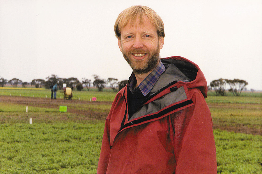 Hugh Wallwork standing in a paddock. 