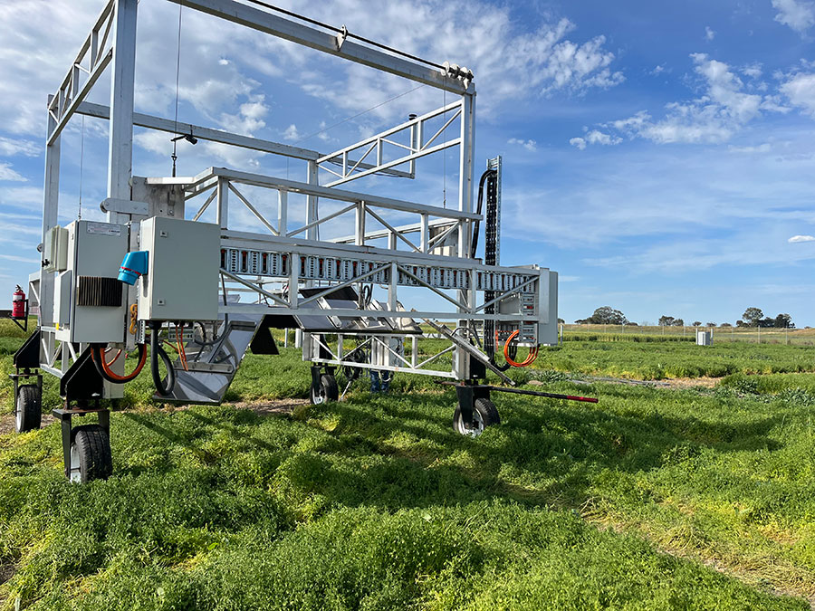 A metal trolley in a grassy paddock