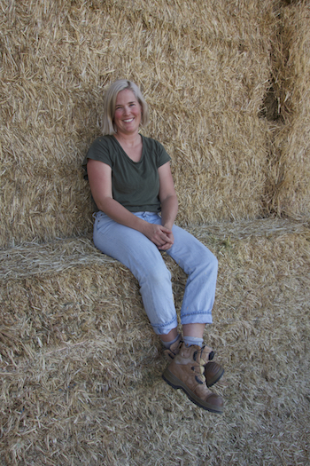 Lou Flohr sitting on hay bales.