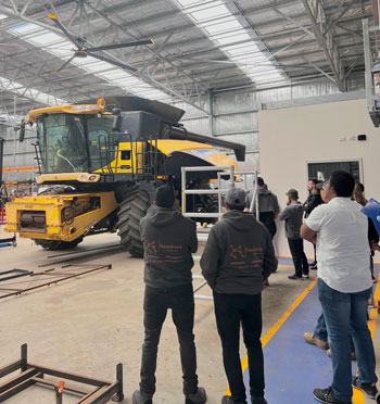 men in awarehouse looking at a machine