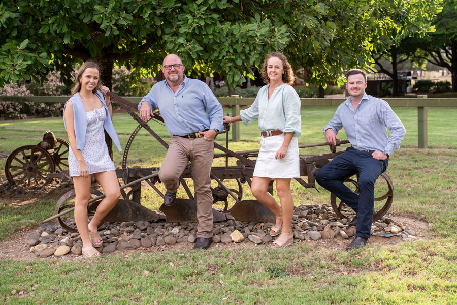 The russell family in their rural garden smiling 