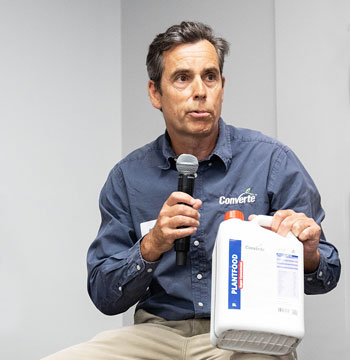 man speaking about product in white container