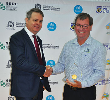 Two men shaking hands in front of GRDC and CSIRO logos