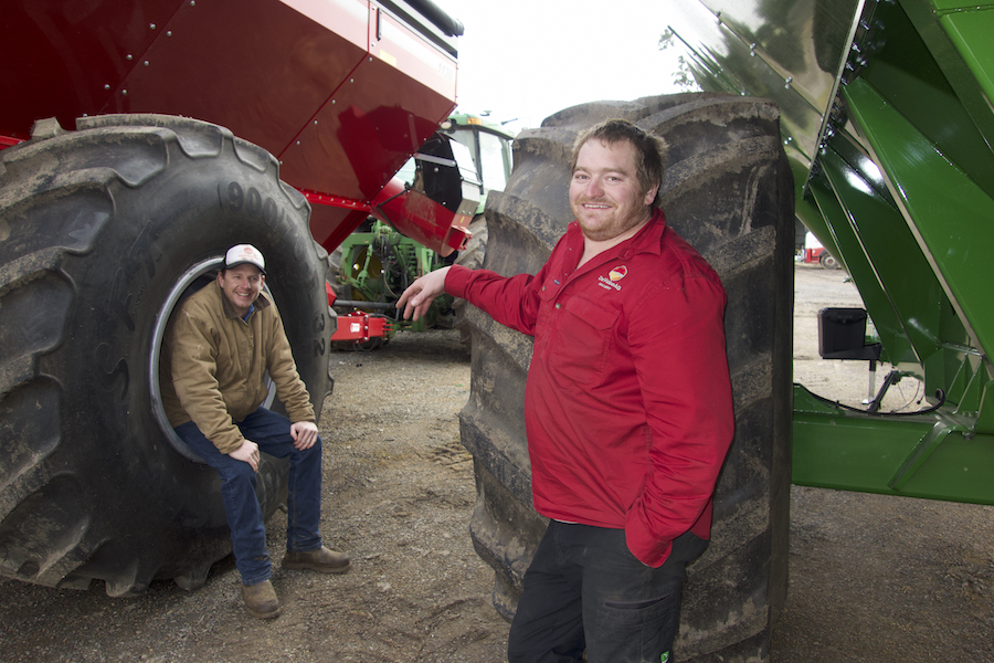 Ben Findlay and Chris Karslake leaning on machinery on-farm at Weatherboard, Victoria. 