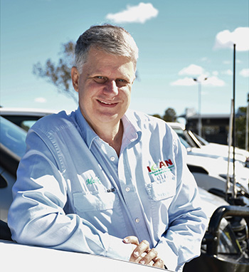 Man leaning on front of car