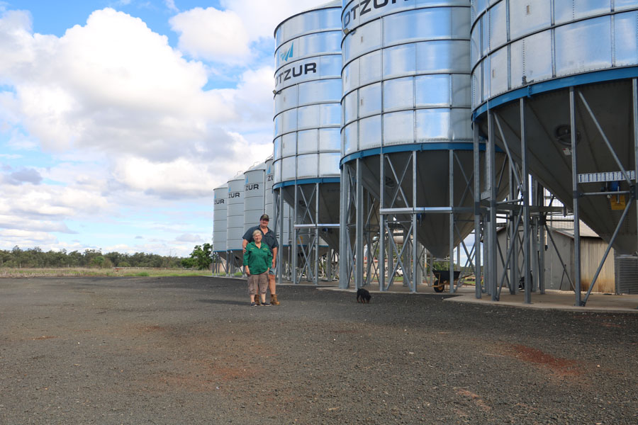 Meridith and Gordon Staal standing together next to a row of large silos.