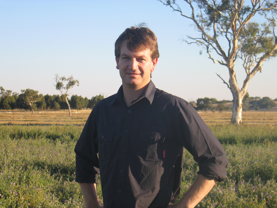 Dr Rick Llewellyn standing in a paddock. 