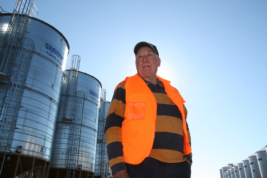 Wayne Anderson standing among silos at the on-farm grain storage facility.